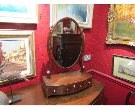 A George III crossbanded mahogany dressing chest oval mirror with bone handles to a three drawer bow front base on outswept b