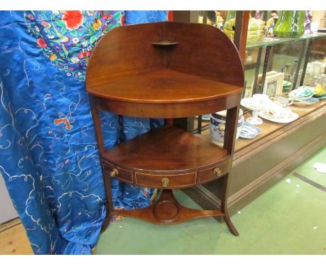 A George III mahogany bow front three tier washstand with single drawer over outswept legs