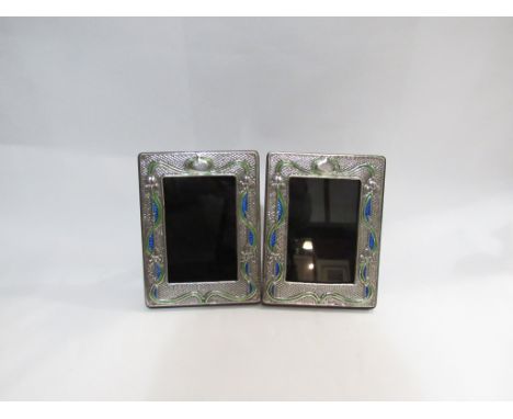 A pair of Art Nouveau silver and enamel photograph frames, 19cm x 14.5cm each