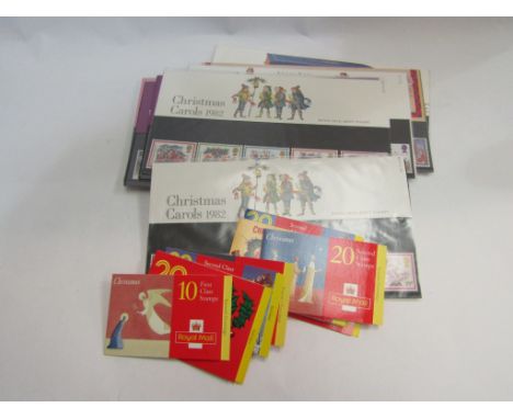 A collection of Royal Mail Mint Stamp packs Christmas' 1982-1987 together with two books of 10 x 1st class Christmas stamps, 