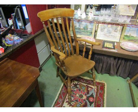 A modern stick back armchair with scroll arms on turned legs and stretcher base