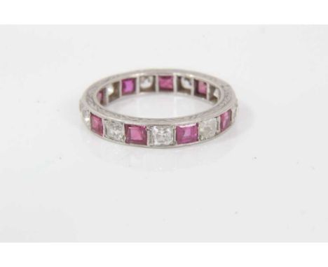 Ruby and diamond eternity ring with a band of old cut cushion shape diamonds interspaced by calibre cut rubies. Estimated tot