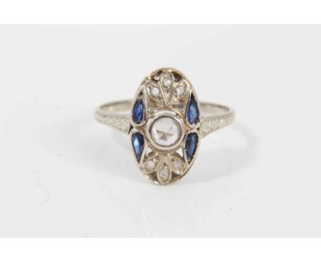 Art Deco diamond and sapphire plaque ring with an oval openwork plaque with a central rose cut diamond, four pear cut blue sa