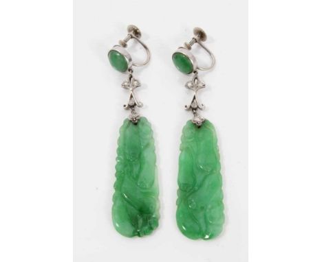 Pair of Chinese carved green jade pendant earrings, each with a carved and pierced jade plaque suspended from a jade cabochon