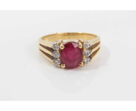 18ct gold diamond and red stone dress ring with an oval mixed cut red stone (possibly a synthetic ruby) flanked by six brilli