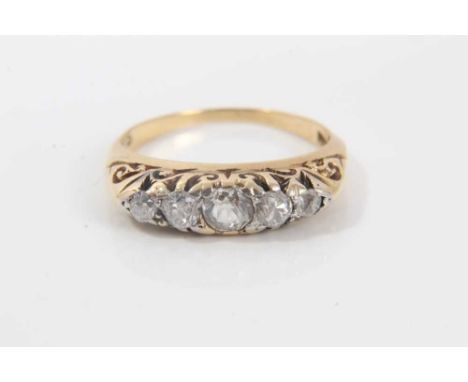 Late Victorian diamond five stone ring with five graduated old cut diamonds in carved gold claw setting on 18ct gold shank, r