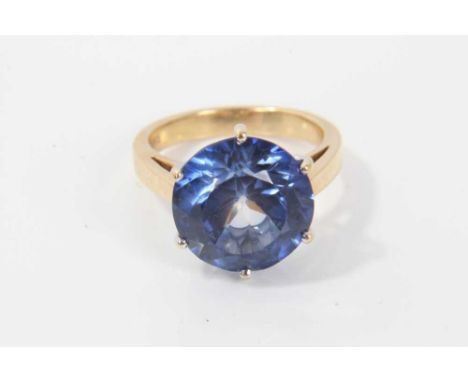 18ct gold dress ring with a large round mixed cut blue stone measuring approximately 13mm diameter in claw setting on 18ct ye