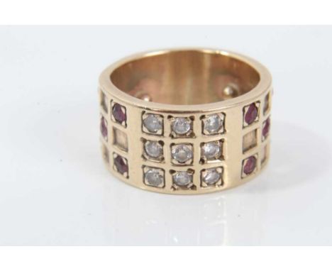 Diamond and ruby ring with a wide 9ct yellow gold band with brilliant cut diamonds and mixed cut rubies in a grid-style setti