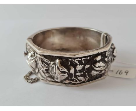 A wide silver embossed hinged bangle 