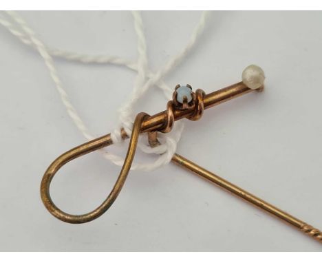 A unusual arts and crafts stick pin in the form of a riding crop with opal and pearl stones 