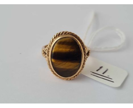 A oval  tigers eye ring with 9ct chased and pierced mount size N - 4.4 gms 