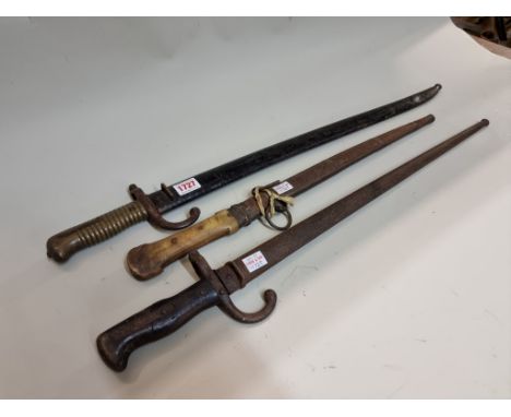 Two French bayonets and steel scabbards; together with a yatagan dagger with horn handle. (3) 