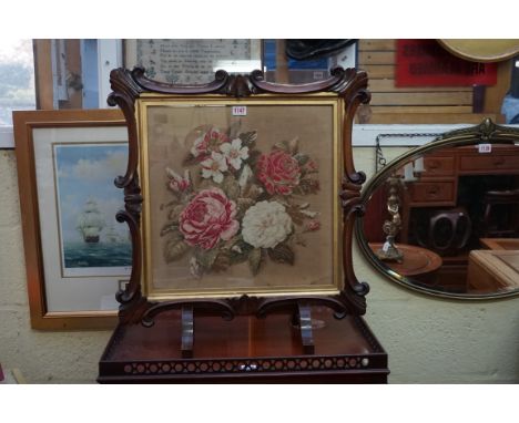 A Victorian rosewood framed gros point firescreen panel, 60cm wide, on associated stand.&nbsp; 