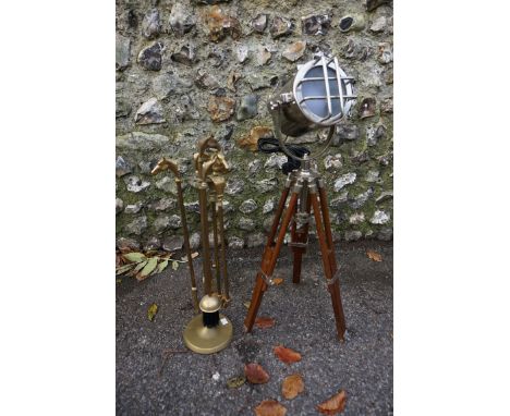 A tripod stage light style lamp; together with a set of brass fireside tools. 