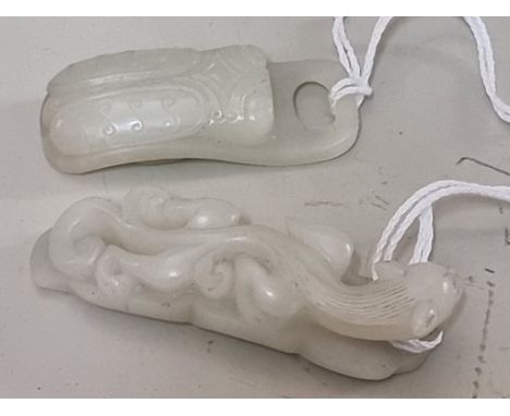 Two Chinese carved pale celadon jade carvings, comprising: a beetle buckle, 5.7cm long; and a carving of a lingzhi dragon on 