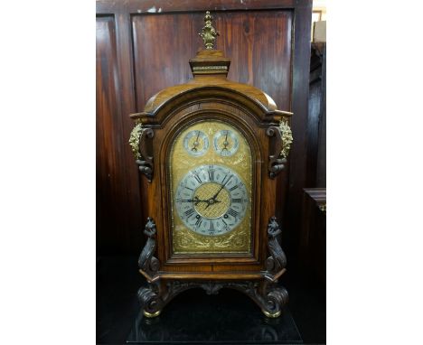 A large and impressive early 20th century carved oak and brass mounted clock and bracket, by&nbsp;'W &amp; H', the clock 73.5
