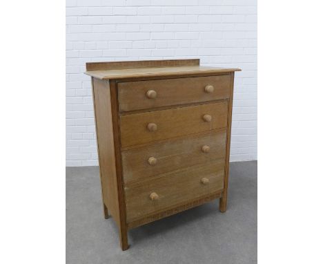 Early 20th century light oak chest, with a foliate carved ledgeback and moulded edge top,  above four graduating long drawers