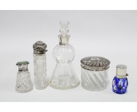 A group of four silver mounted glass scent bottles to include a thistle shaped bottle with stopper, Birmingham 1910, blue fla