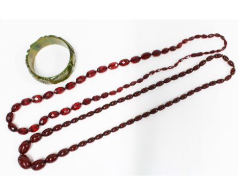 A vintage strand of faux cherry amber beads, a green bangle and a strand of faceted beads, (3)