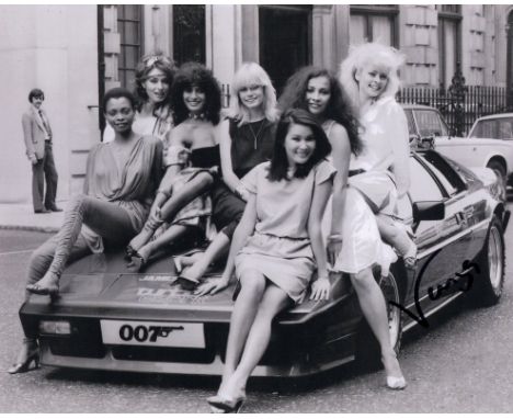 007 James Bond actress and topless Page 3 model Vanya Seager signed 8x10 Octopussy girls with car candid photo!. Good conditi
