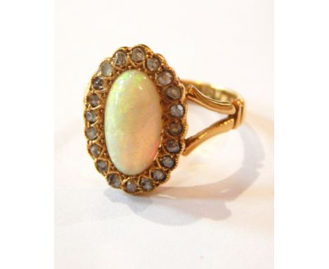 18ct gold, opal and diamond cluster ring set oval cabochon opal with surround of tiny diamonds 