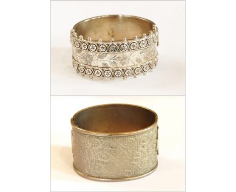 Victorian silver bangle with applied and engraved floral decoration together with another bangle (2) 