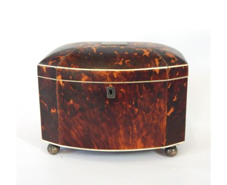 A 19th century bow-front tortoiseshell tea caddy, the top with inset engraved plate, opening to reveal a pair of compartments