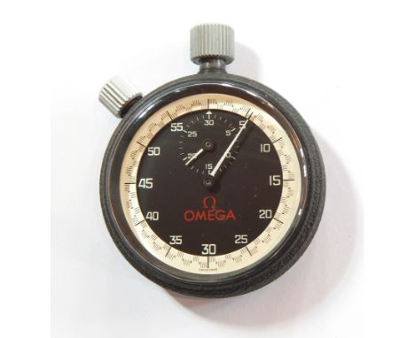 An Omega stopwatch with black dial, the minute sweep and with 30 second subsidiary dial, Swiss made, in a heavy duty metal ca