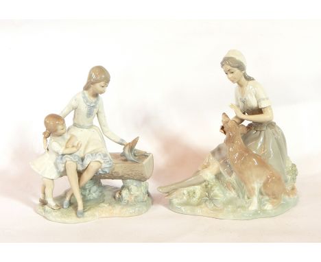 A Nao figure of a girl petting a large dog and a Nao group of a girl with a little girl, feeding doves (2) 