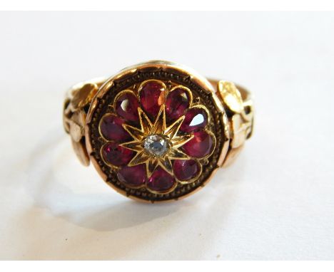 Gold, ruby and diamond dress ring, the circular setting with central old-cut diamond surrounded by pear-shaped cut rubies wit