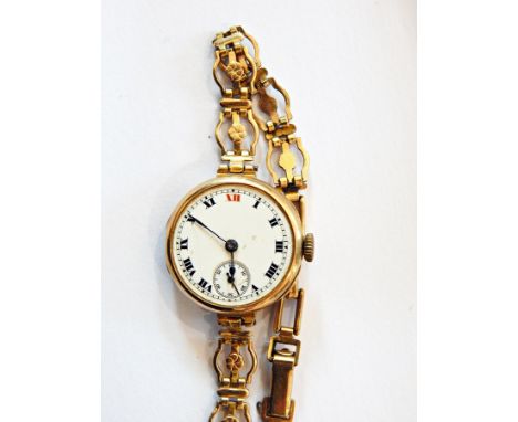 Lady's 9ct gold wristwatch circular with subsidiary seconds dial, on rolled gold pierced strap and continental silver-coloure
