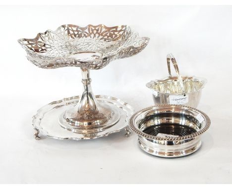 A silver-plate pierced fruit bowl on a raised stem and circular foot, a wavy-edged waiter, wine coaster, shell-shaped butter 