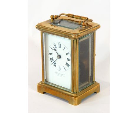 A French carriage clock timepiece, the brass case with glazed panels, enamel dial with Roman numerals, retailed by John Littl