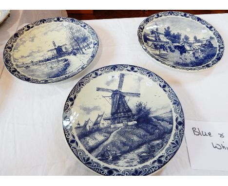 Three Delft chargers depicting a printed windmill and workers, 39cm wide, picture of windmill in background, pond, horse and 
