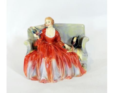 A Royal Doulton porcelain figure 'Sweet and Twenty', of a lady seated on a sofa in formal dress, 18cm 