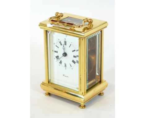 A brass carriage clock timepiece with glazed panels, enamel dial with Roman numerals, marked "Worcester", by Fema, London, he