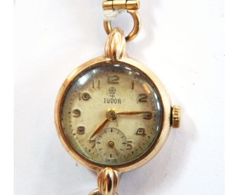 A lady's Tudor .375 gold wristwatch with silvered dial and subsidiary seconds hand, on a chain link bracelet 
