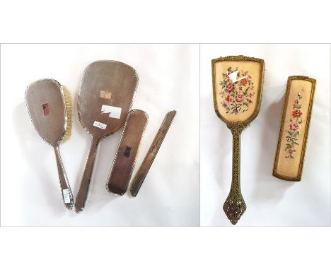 A silver-backed dressing table set comprising hand mirror, hairbrush and comb mount, Birmingham 1930 together with a gilt met