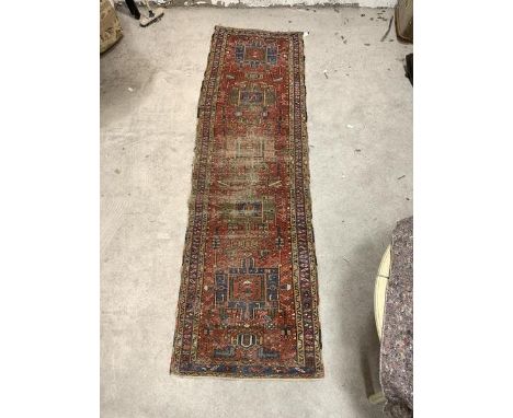 A hand knotted runner rug, probably North West Persian, of all over geometric design, 308cm x 86cm