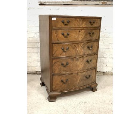 An Early 20th century mahogany bow front chest, fitted with five graduated drawers, raised on ogee bracket supports, H99cm, W