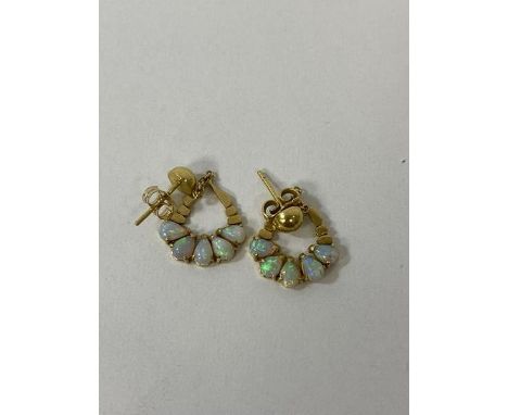 A pair of yellow metal opal set earrings measure 1cm across, 1 back marked 14 the other 18