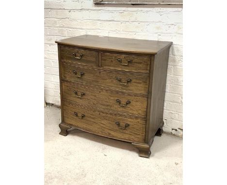 An Edwardian mahogany bow front chest, fitted with two short and three long graduated drawers, raised on ogee bracket support