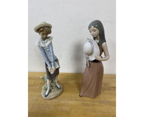 Two Lladro figures, one of a girl with spectacles and books and flowers, the other holding a hat, measures 25cm high