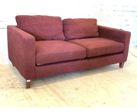 A modern two seat sofa, upholstered in purple fabric, raised on square tapered supports, H65cm, W173cm, D94cm