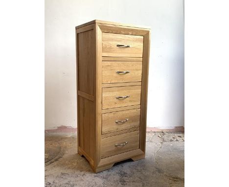 A contemporary light oak tall chest, fitted with five drawers, H120cm, W53cm, D43cm