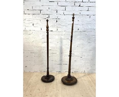 A stained beech turned and carved standard light (H163cm) together with another (H159cm)