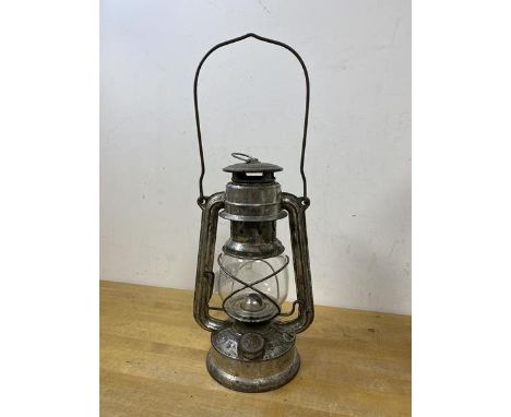 A German oil lantern inscribed Western Germany Baby Feuer Hand, glass marked Jena Glass, measures 26cm high