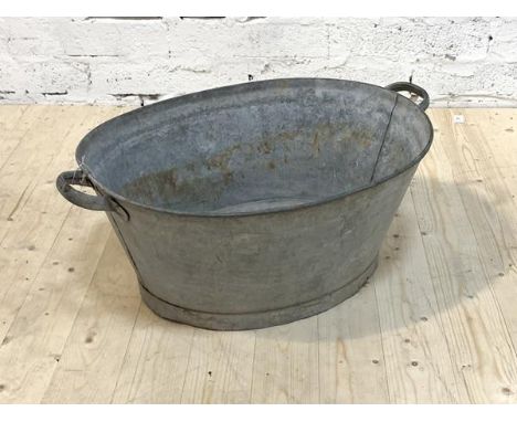 A twin handled galvanized bath tub or planter, H31cm, W80cm, D36cm