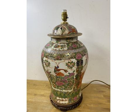 A 19thc famille rose lidded baluster shaped vase later converted to table lamp on wooden base, measures 56cm high