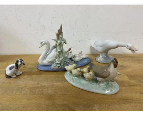 A collection of Lladro animals including a swan with cygnets, measures 12cm high a/f, also a goose, a puppy and a Nao mother 